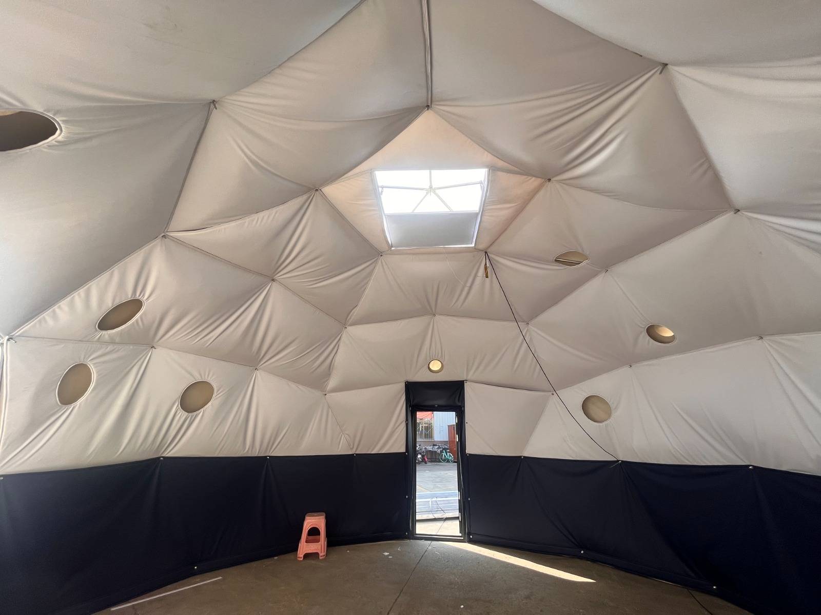 Interior of geodome showing window blinds and furniture